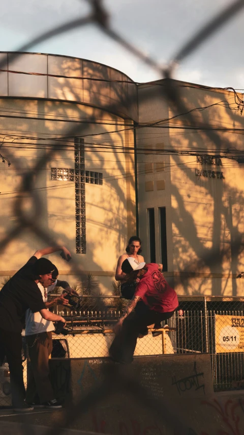 two people with a skateboard near a tall building