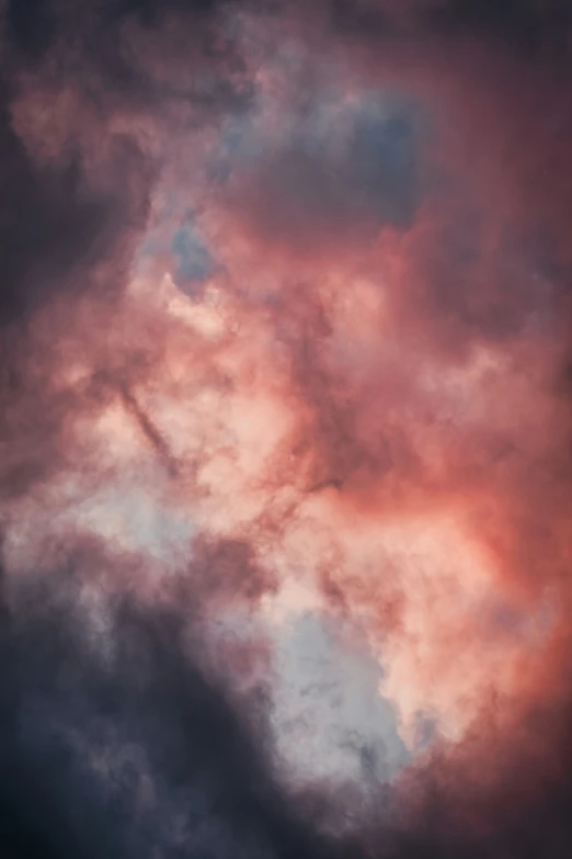 a cloudy sky has pink and blue clouds