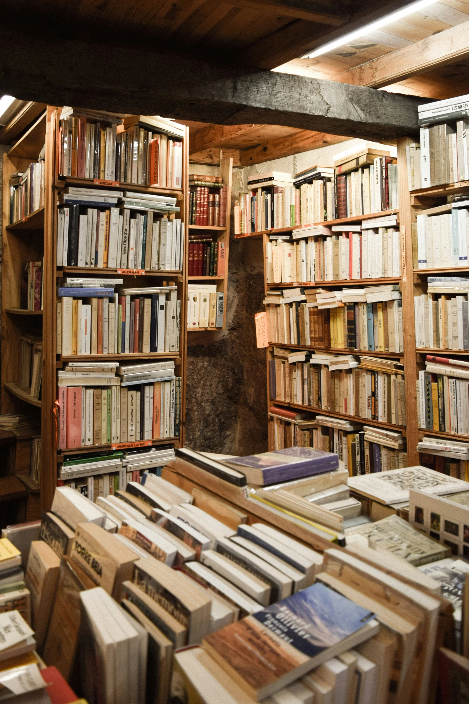 a group of wooden bookshelves filled with different types of books