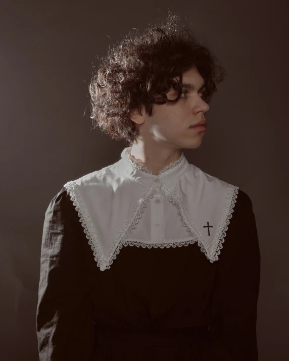 a woman in a black and white dress is staring off into the distance