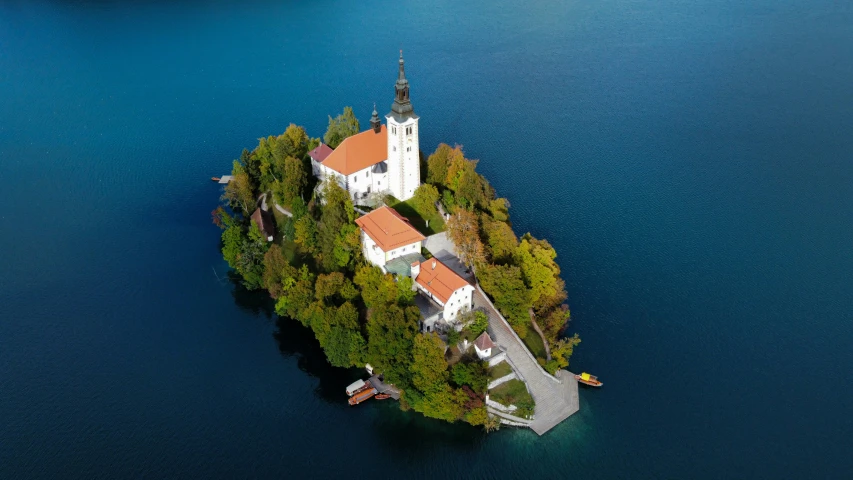 an island with two church's surrounded by blue water