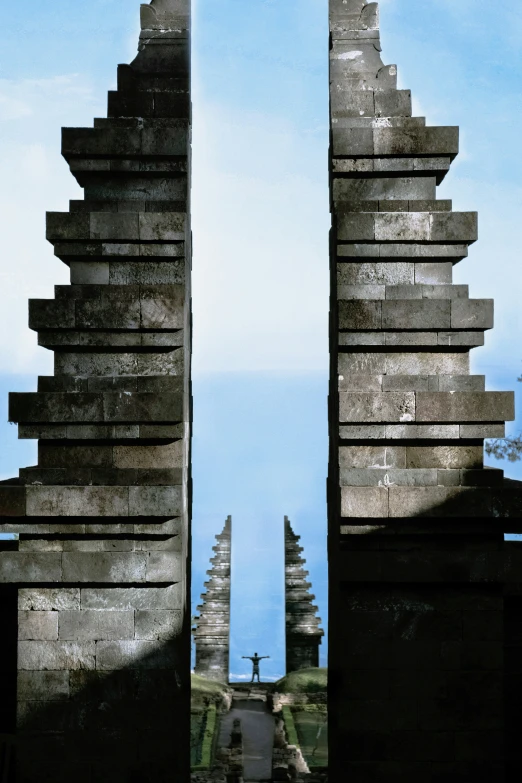 two stone structures against the blue sky