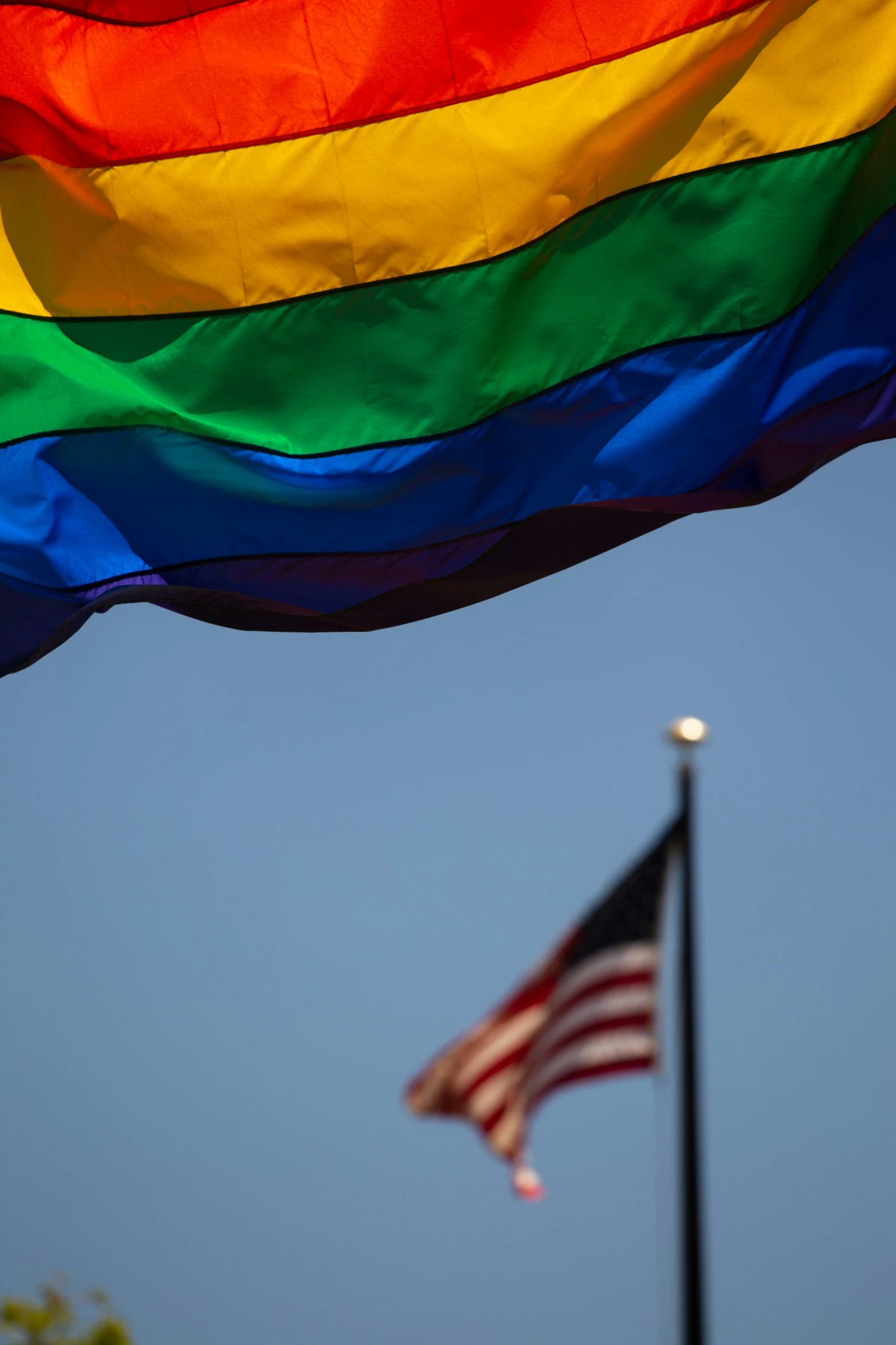 the rainbow flag is next to an american flag