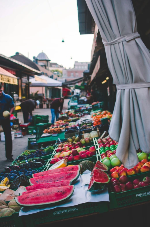 many different fruits are on a market table