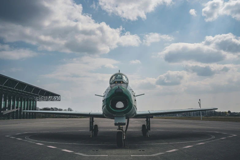 a jet is sitting on the runway on an overcast day