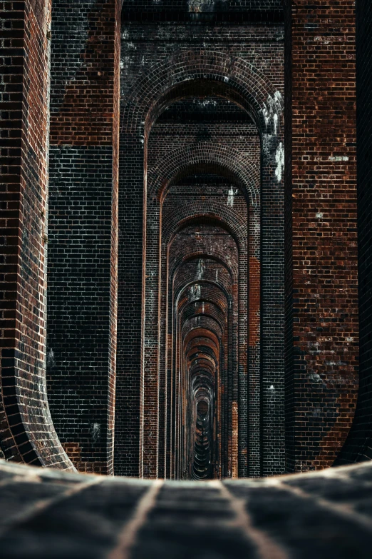 a long tunnel made up of bricks in an alley