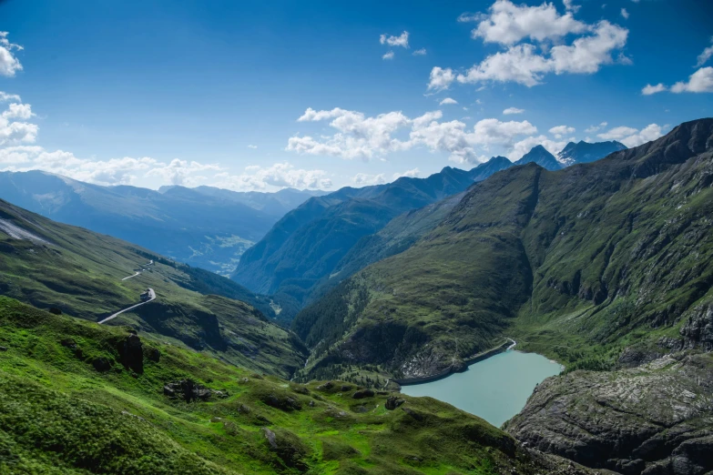 the winding, mountain pass runs down to the water