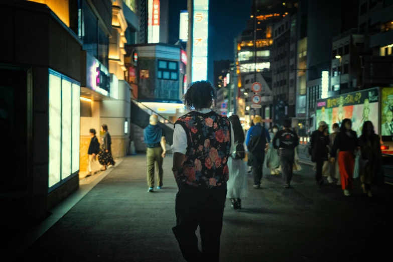 a man standing in front of a neon sign