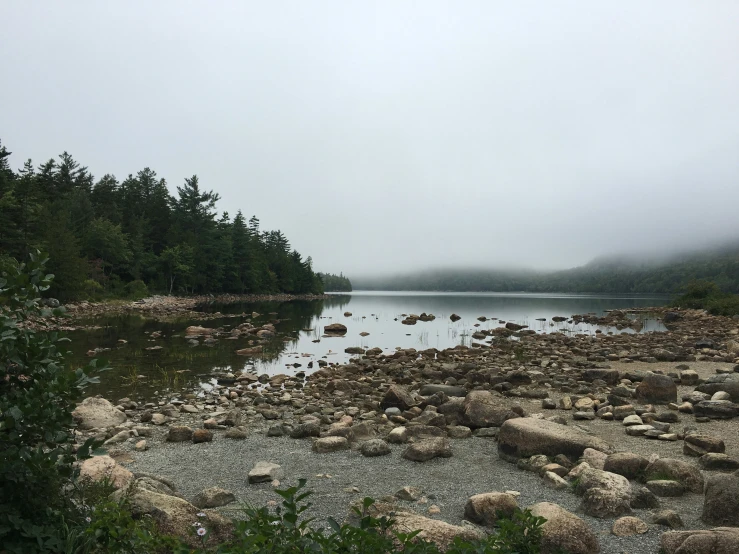 a lake with large rocks and some trees