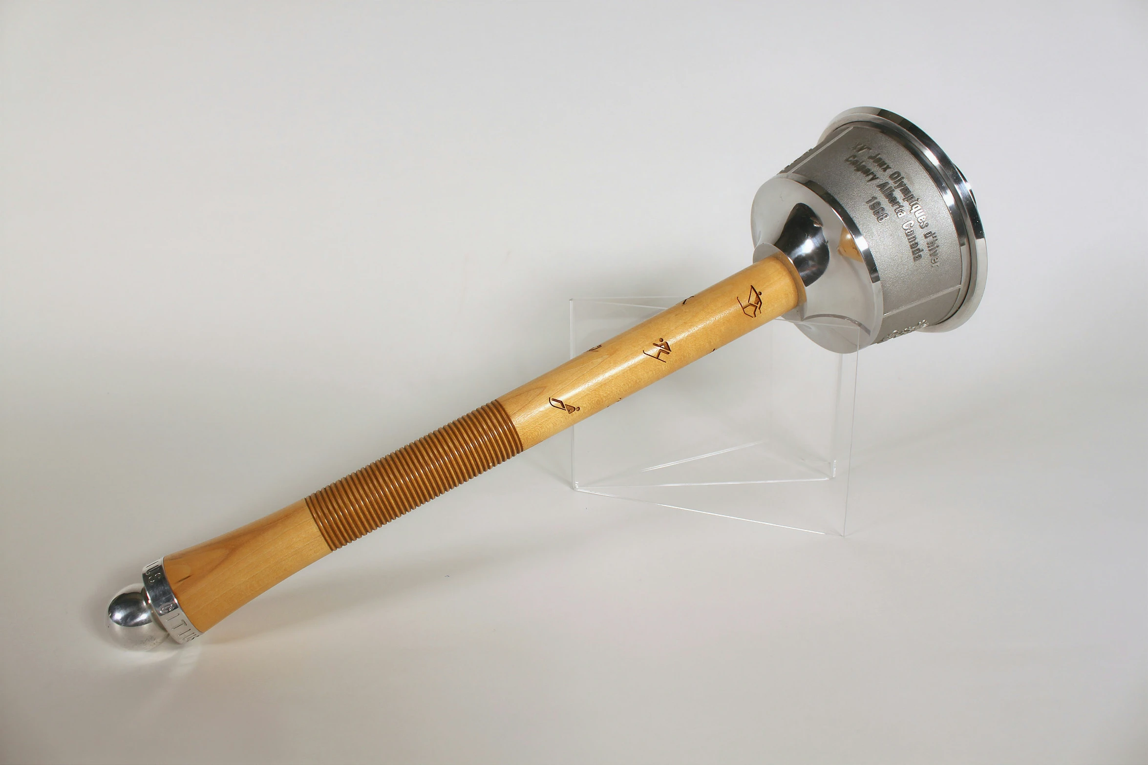 a wooden handle and silver colored metal can opener