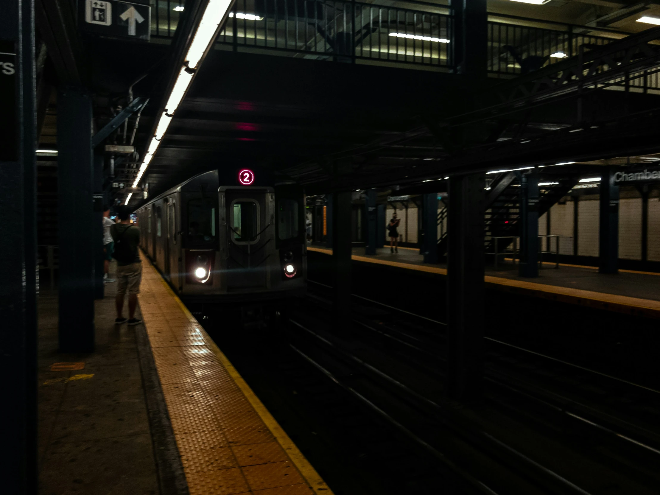 a subway train is in the station as people are boarding