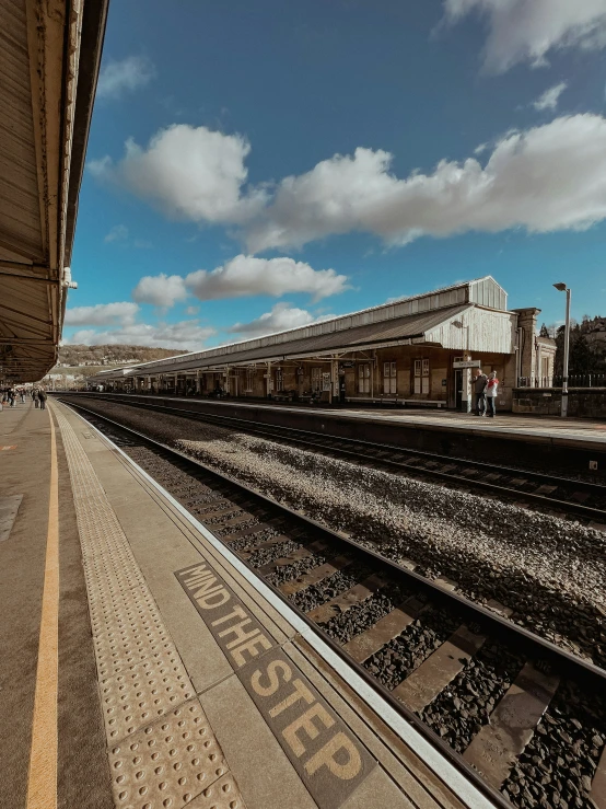 a train tracks sitting on the tracks by a train station