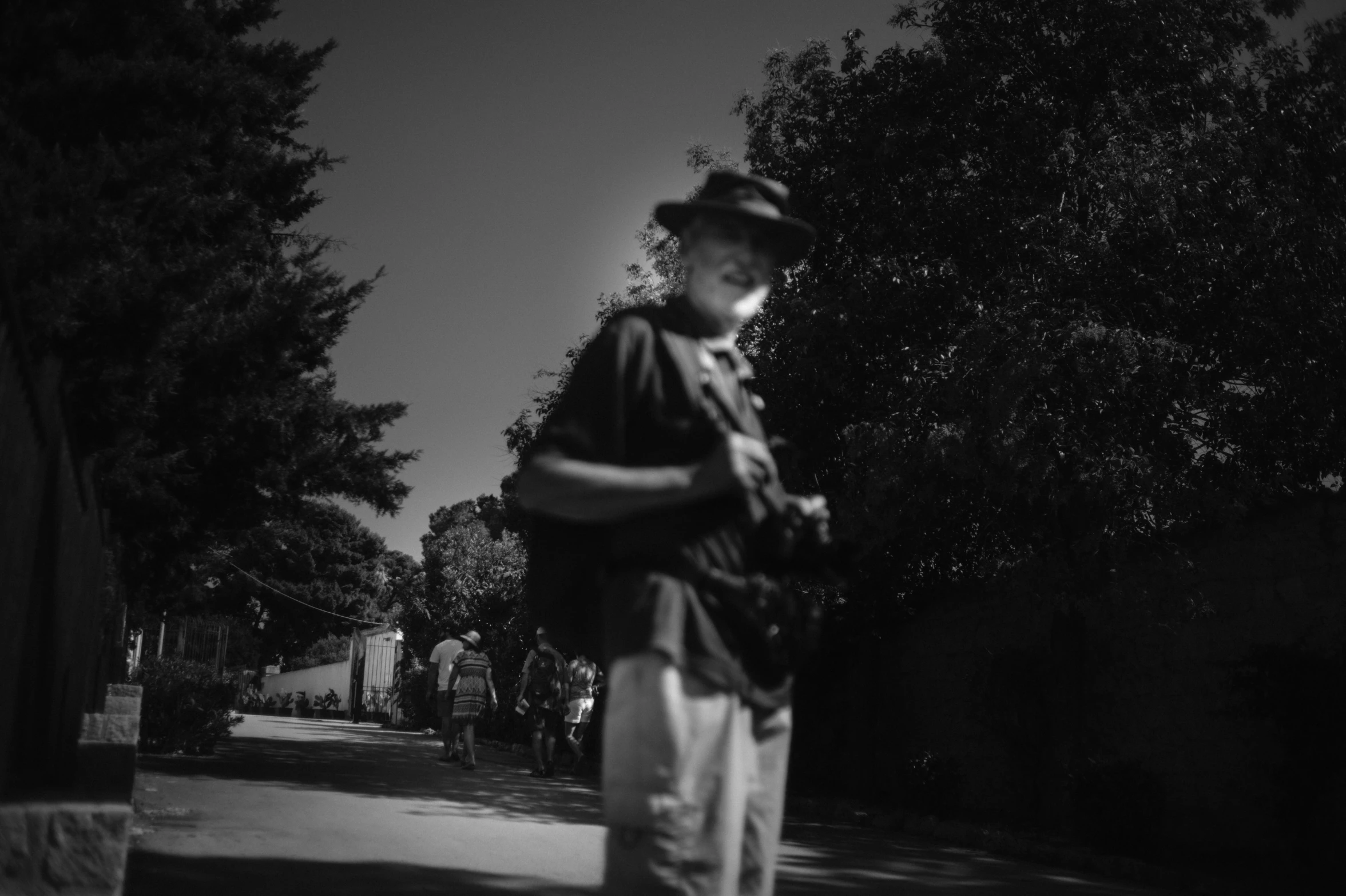 black and white po of a man on sidewalk