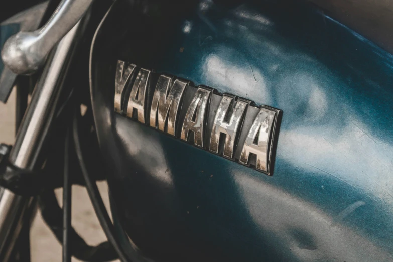 a close up of the emblem on a blue motorcycle