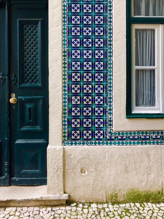 a door in the front of a building with a blue and white pattern