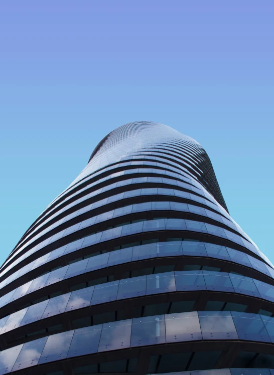 a very tall building with some clouds in the background