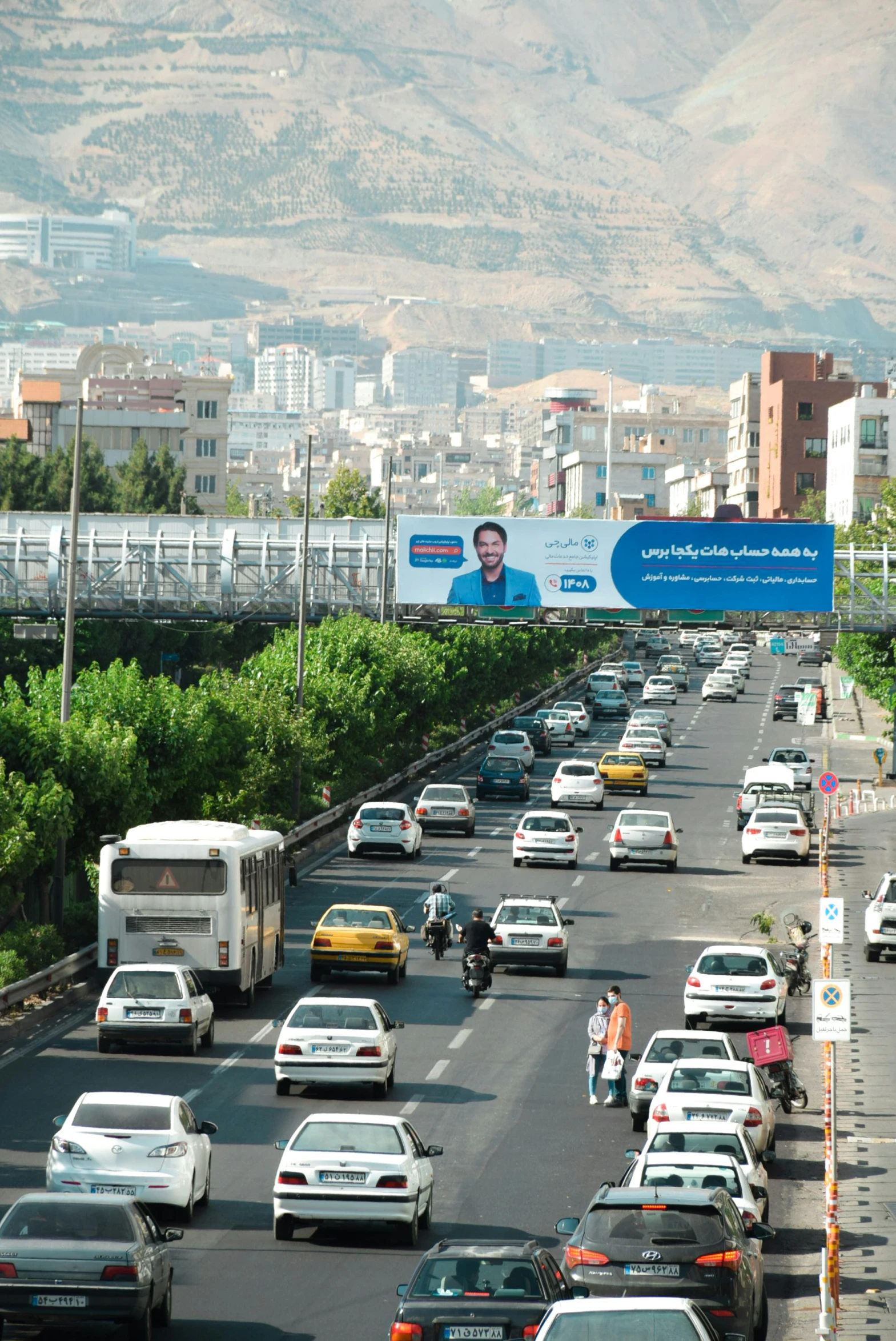 a busy freeway filled with lots of traffic and people on bicycles