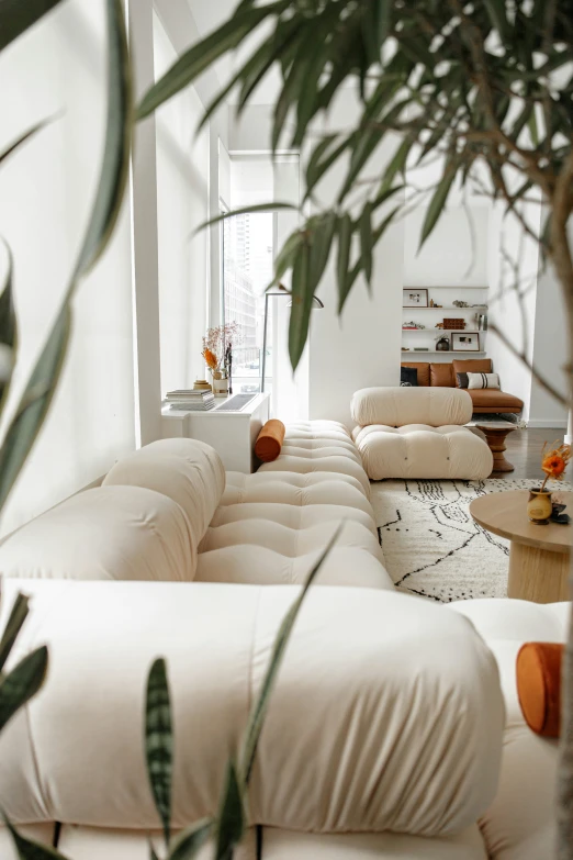 living room with various leather furniture and a white wall