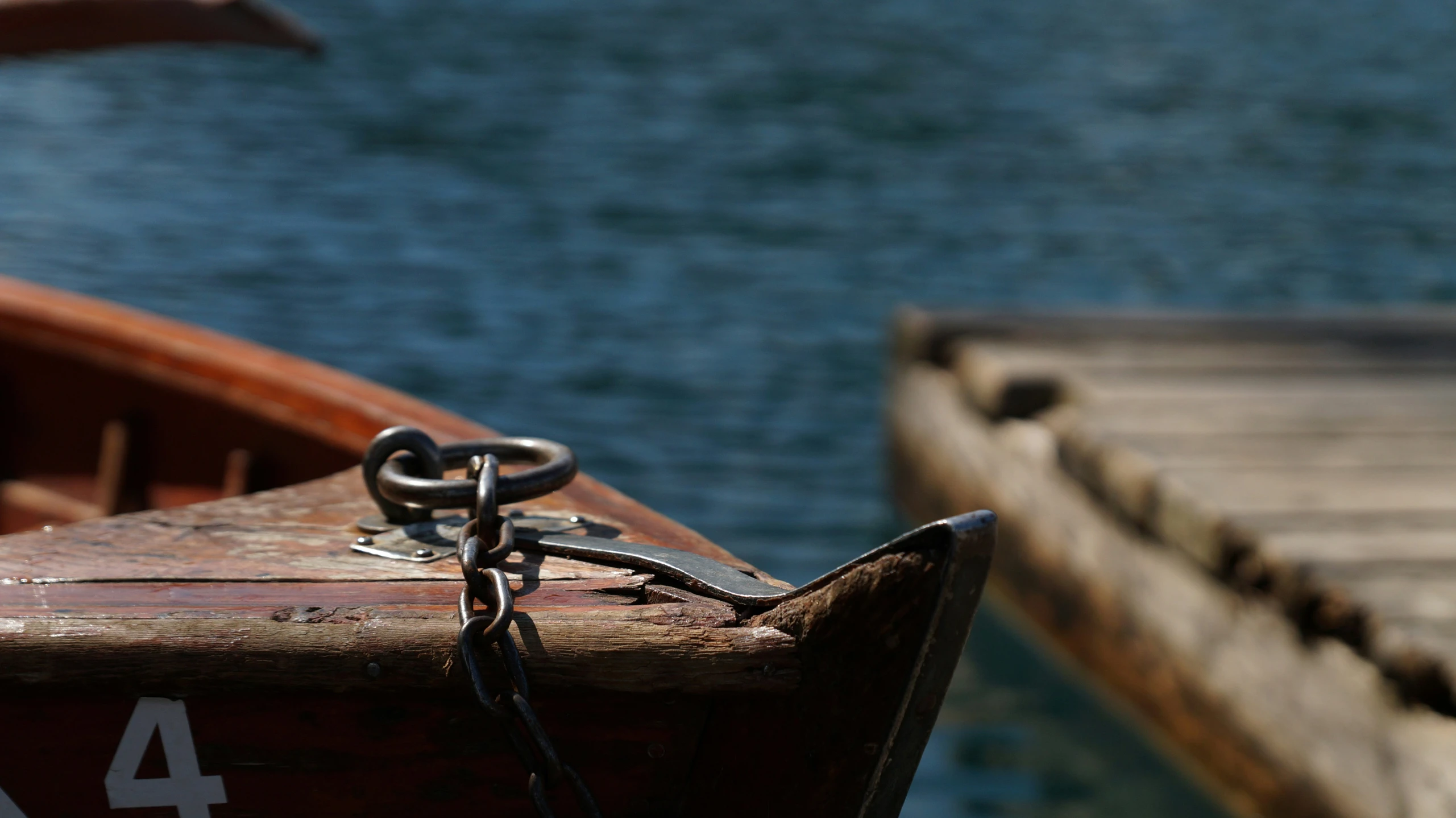 an antique boat docked at the dock with a number 4 on it