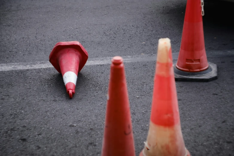 traffic cones with the cone pointing toward a cone that has a long tooth on it