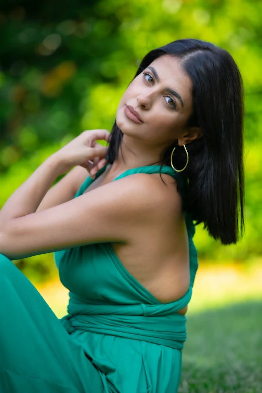 a beautiful young woman with large gold hoop earrings