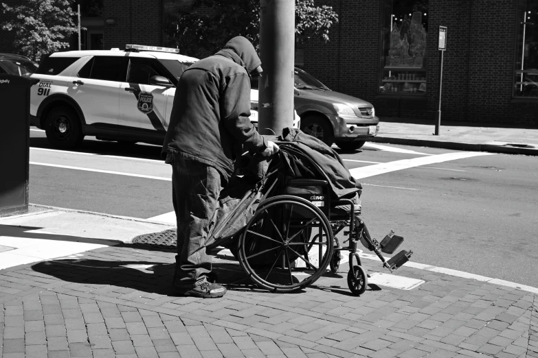 a man hing a child in a stroller down the street