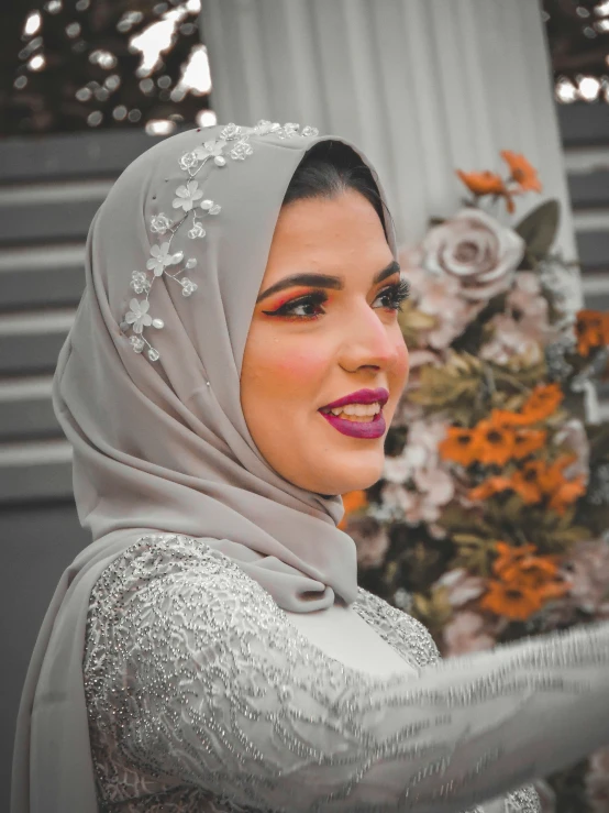 a woman wearing a hijab in a wedding dress