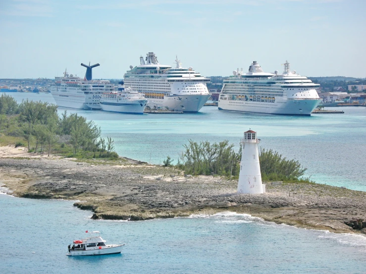 there are many cruise ships and one small boat on the water