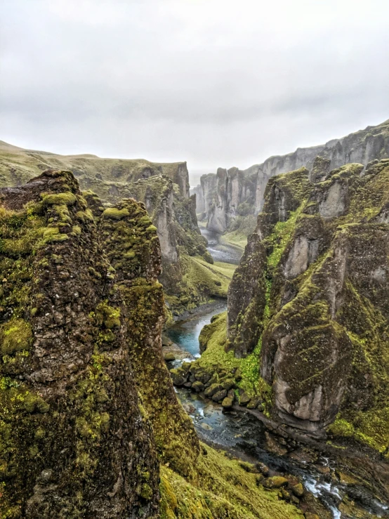 an alpine valley with water flowing from the sides