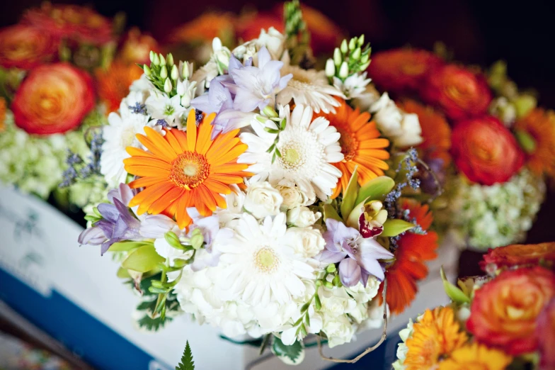 a bouquet of colorful flowers on display in a room