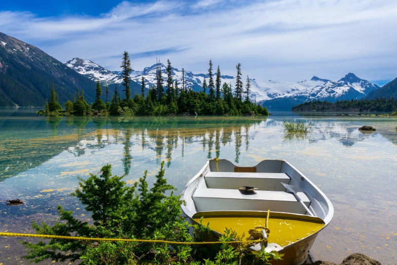 a lone white boat in the middle of a lake