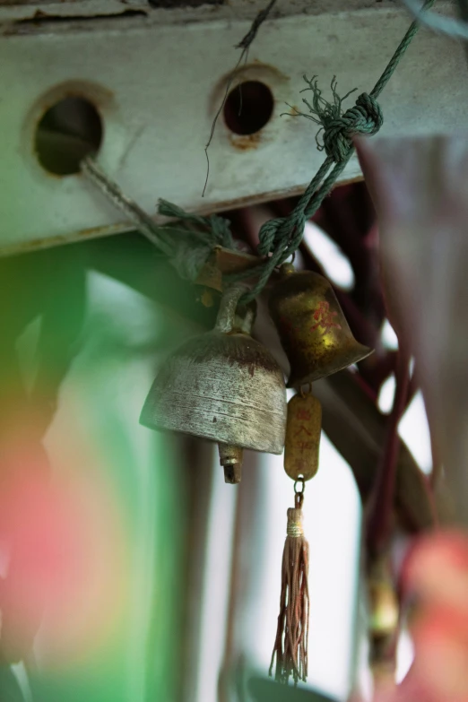 a bunch of bells hanging from the side of a building