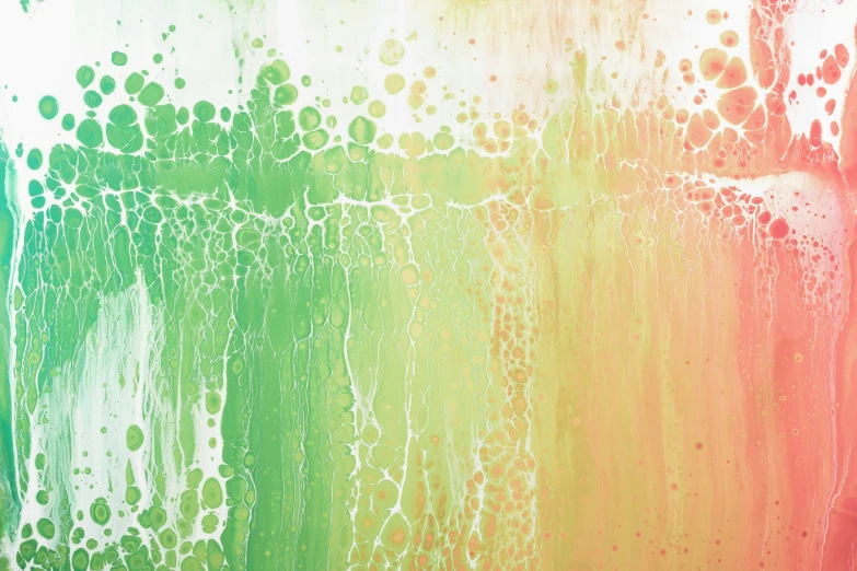 a close up of water drops on colorful paint