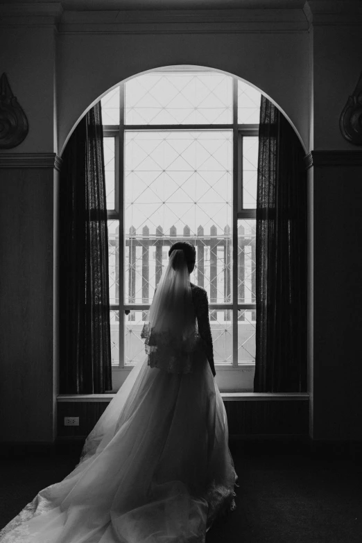 a woman standing in front of a window