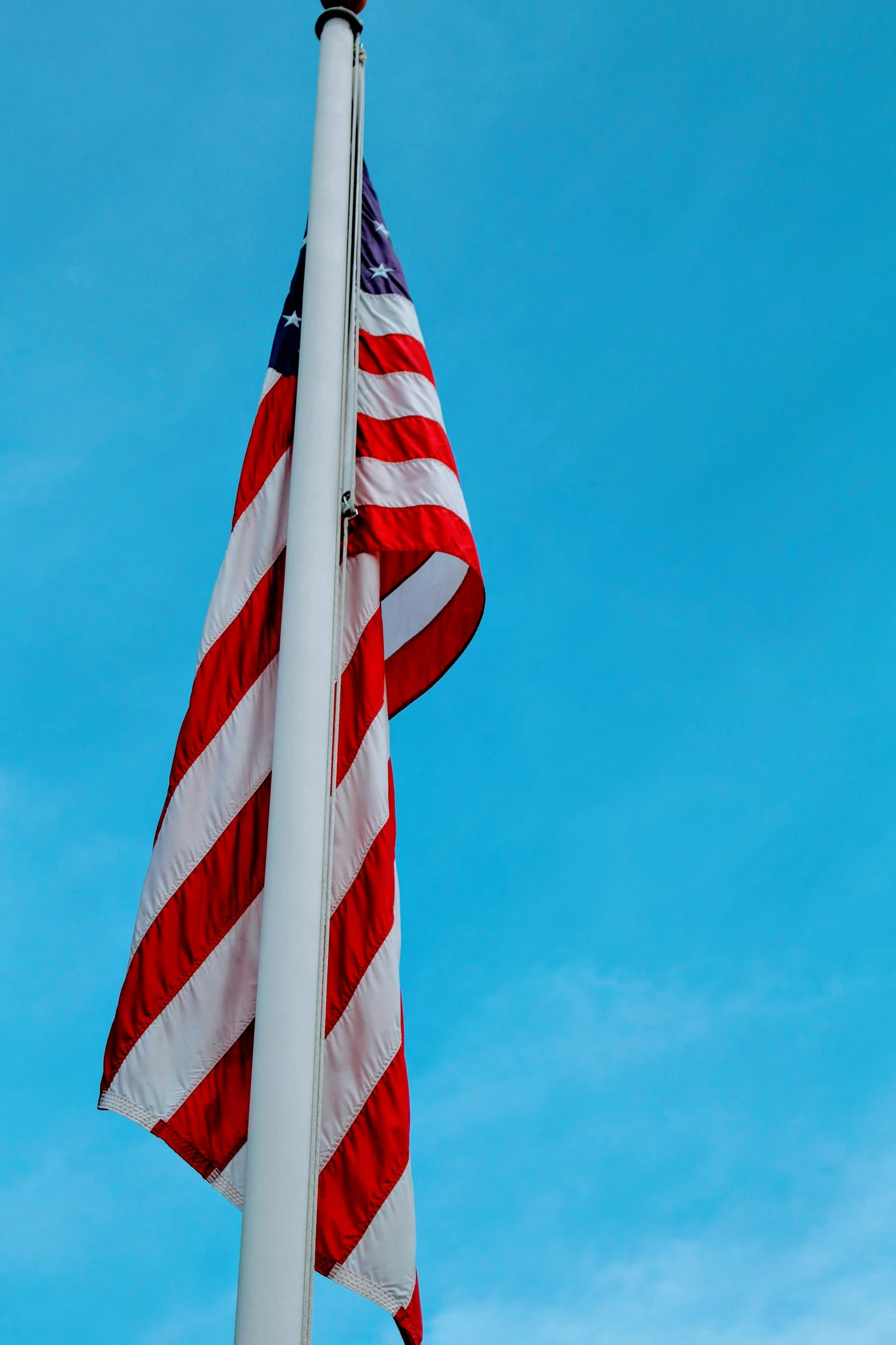 an american flag flies next to a us flag