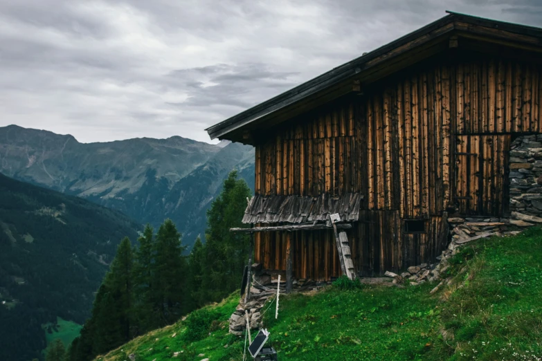 an old house with a mountain view in the background