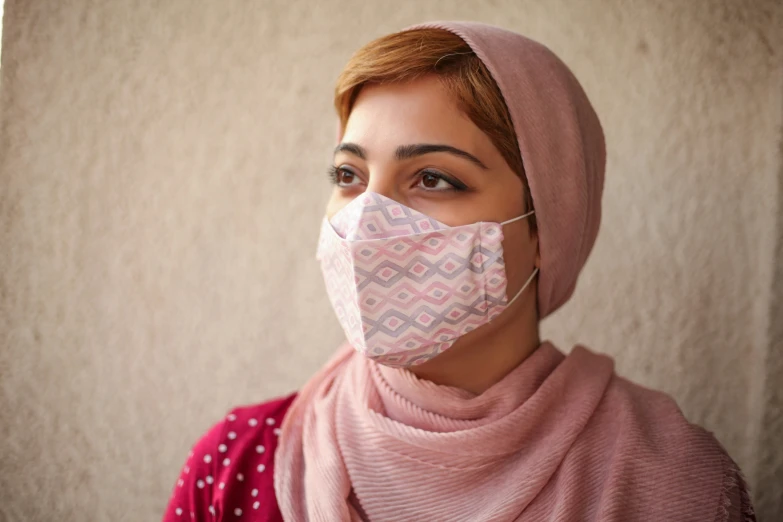 a woman wearing a protective mask while looking to the side