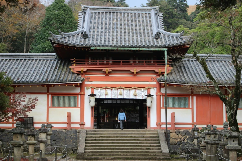 an asian building is in front of trees