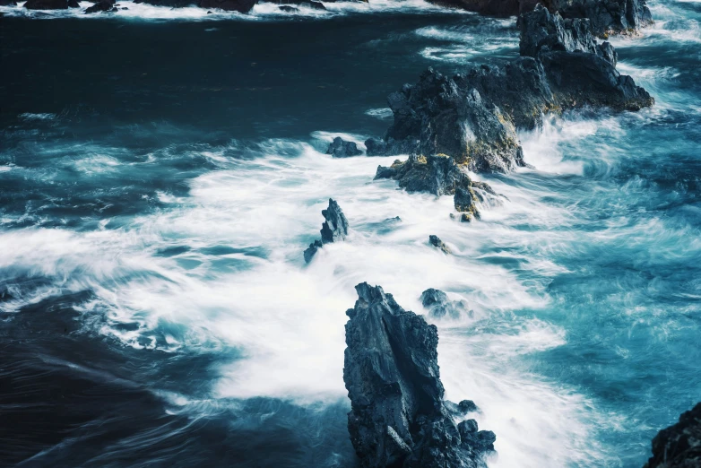 large waves hitting against rocky coastline at night