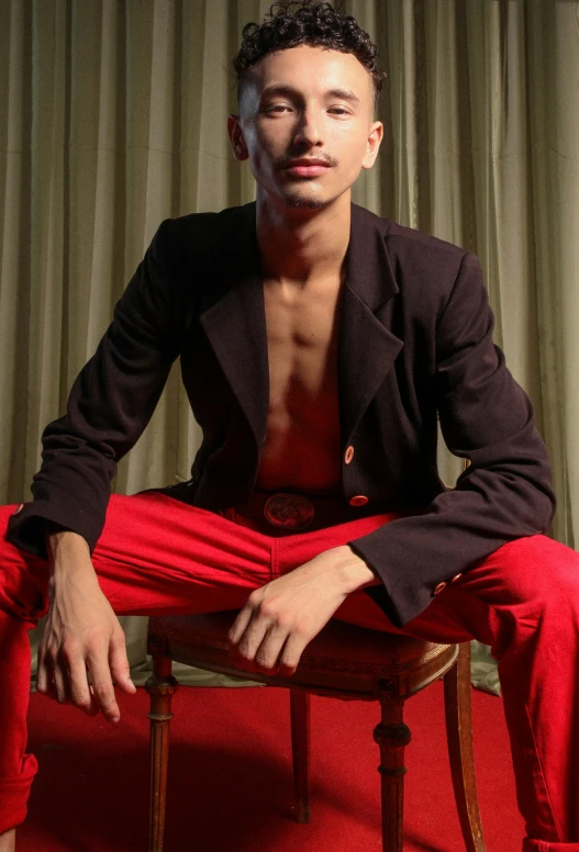 a man sitting on top of a chair near a wall