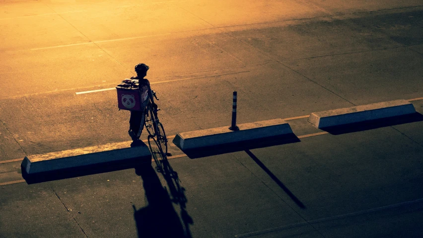 there is a person riding a bike on the street