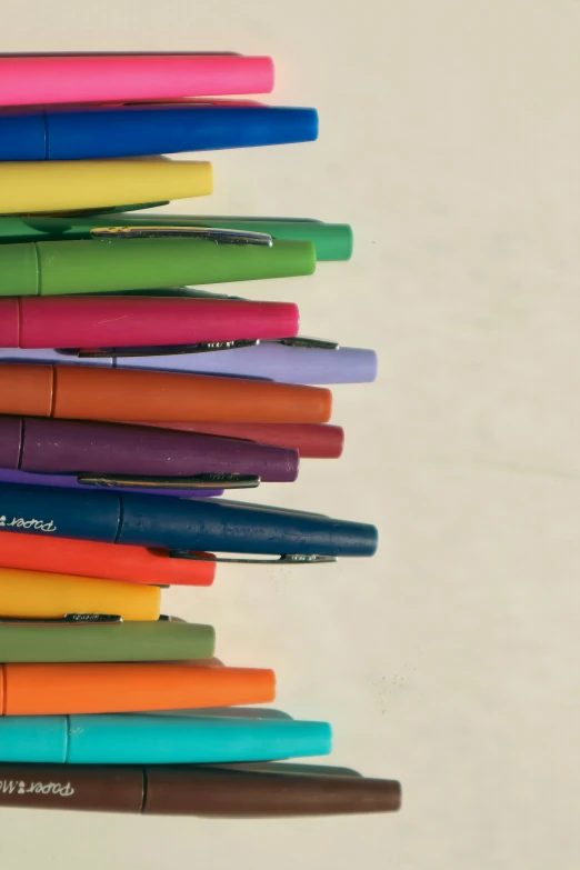 six colored pens lined up in a row