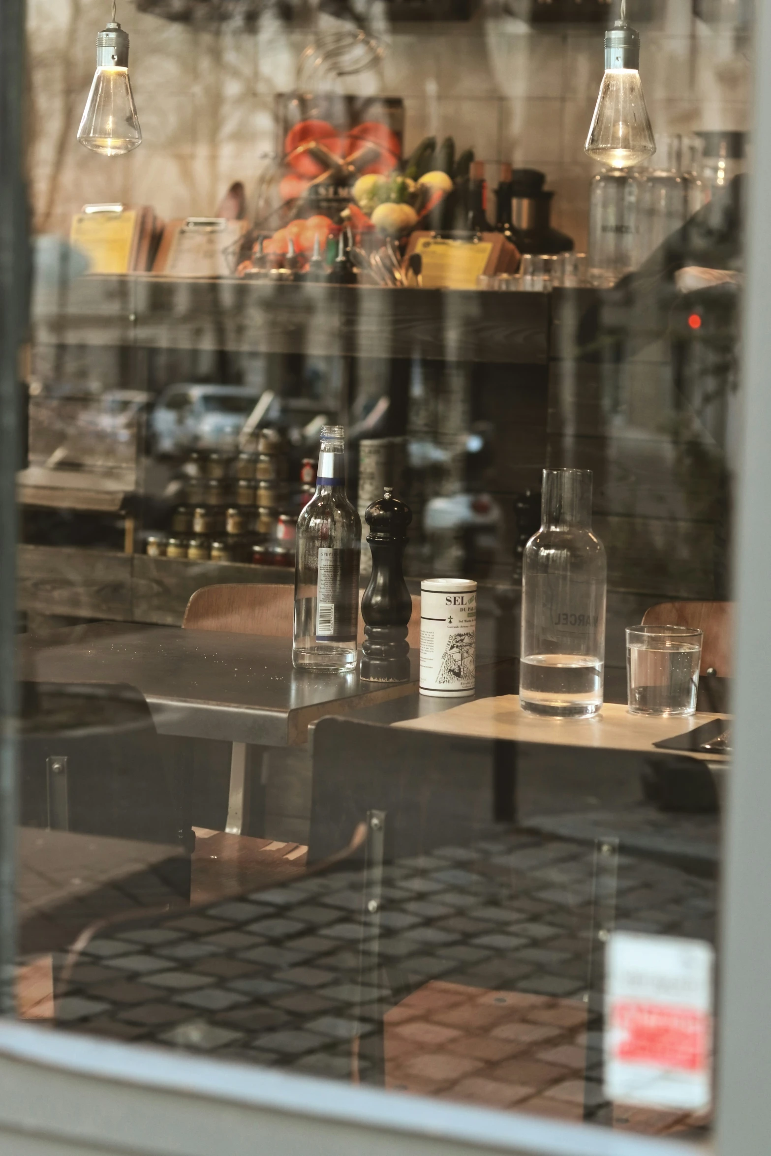 bottles are placed inside the window of an empty restaurant