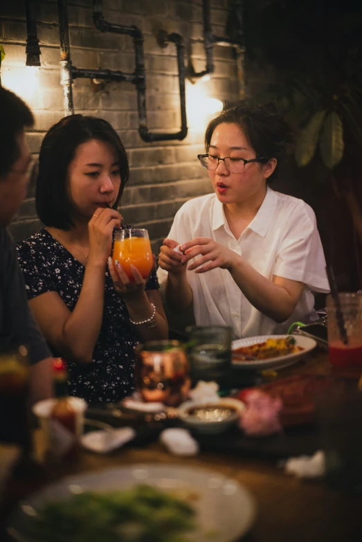 the women are sitting together to enjoy their meal