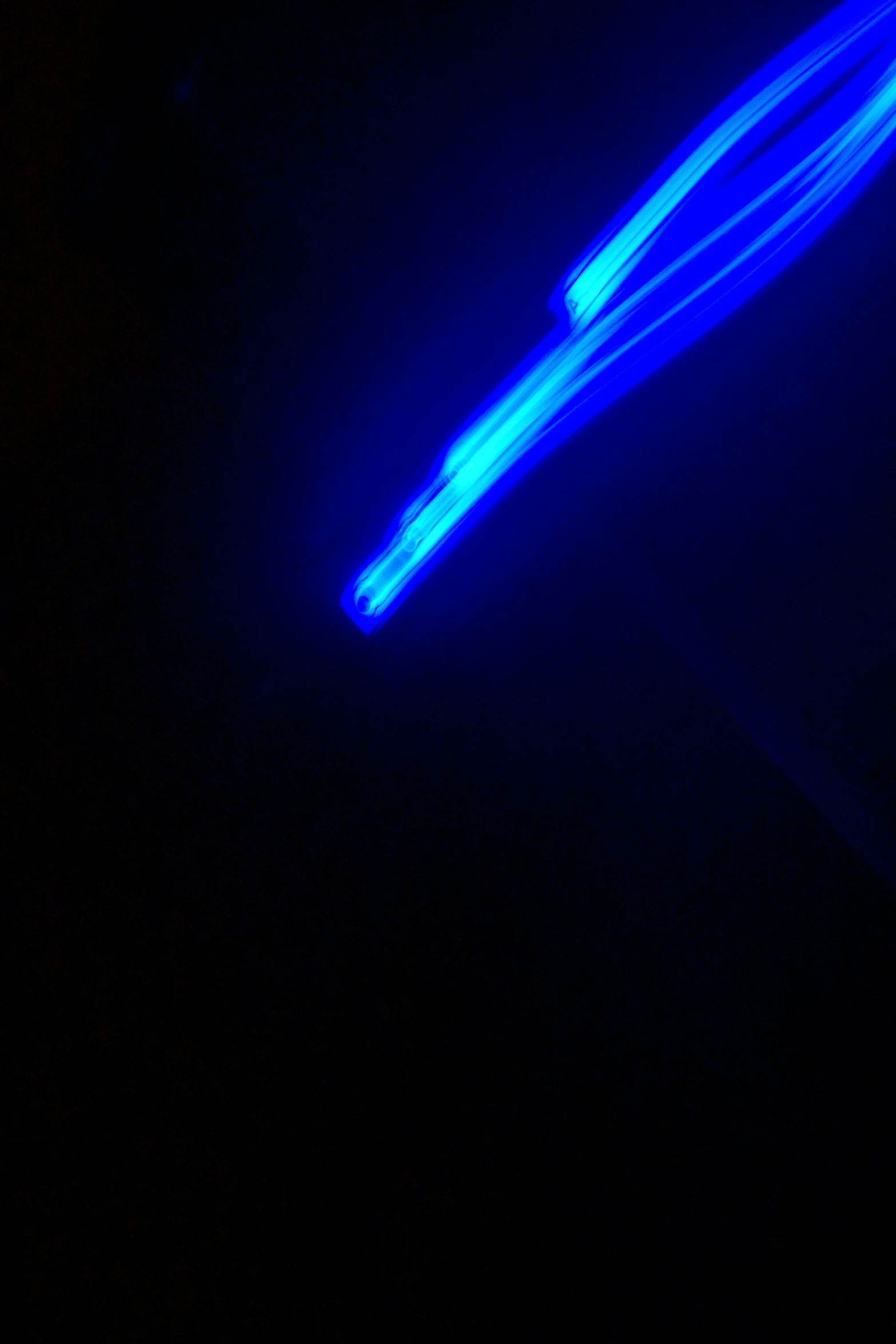 a dark background with a blue light streaks