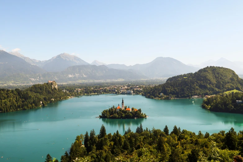 a small island is on the middle of a lake