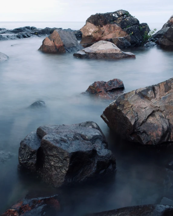 there is an image of some rocks on the water