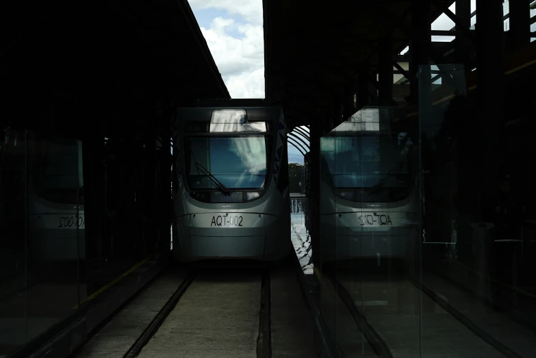 two trains are next to each other at the train station