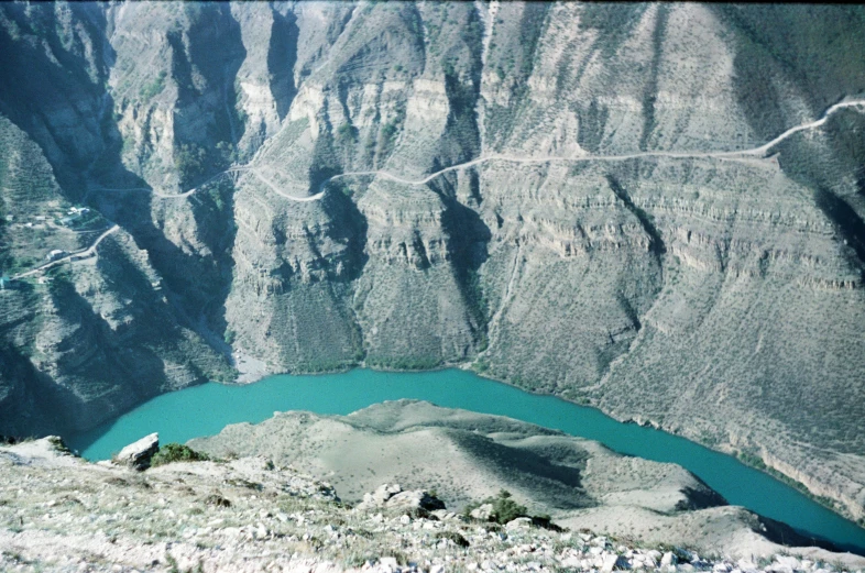 a view from the top of a high mountain looking down over a large body of water and