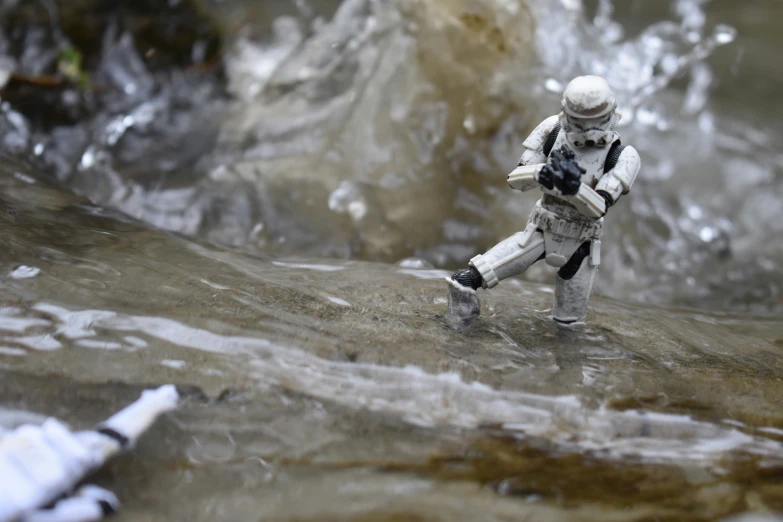 an astronaut is standing in the water with a camera